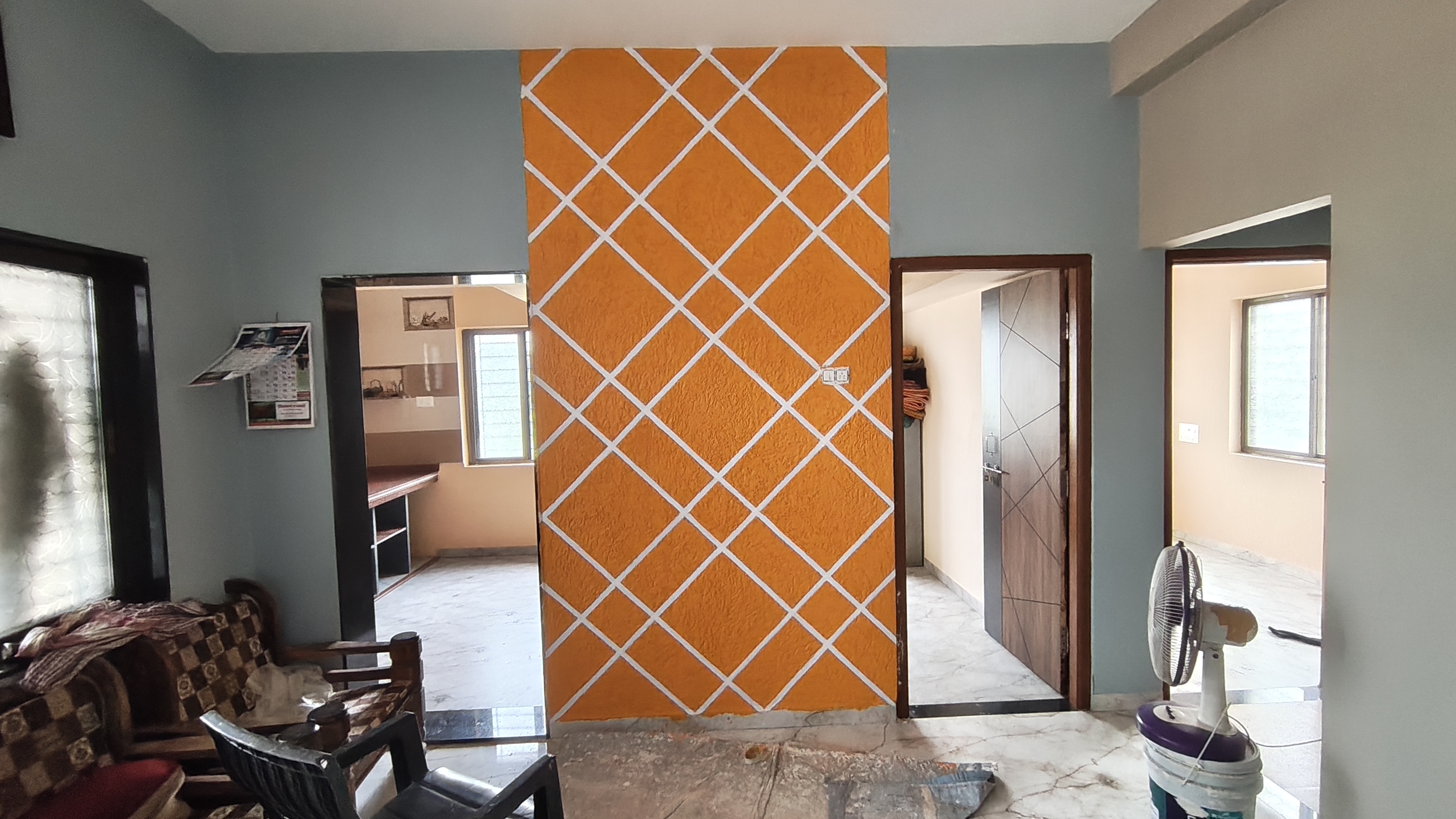 Stylish Orange Geometric Wall Design for Modern Homes | Swapnapurti Paints - Painting Services | Swapnapurti Paints